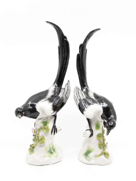 A pair of German porcelain figures of magpies, early 20th Century, modelled after Meissen with each