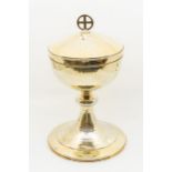 A Modernist hammered silver gilt large chalice and cover, the cover with cross finial, Birmingham,