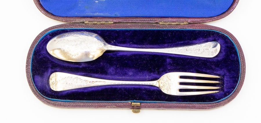 A Victorian silver Christening set comprising fork and spoon, profusely engraved foliate decoration,