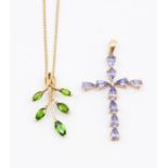 A tanzanite and 9ct gold cross comprising pear cut tanzanite stones, length approx 40mm, along