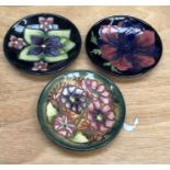 Three small Moorcroft plates/saucers of differing designs all 12cm diameter (3)