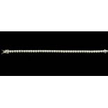 A diamond and 18ct white gold line tennis bracelet, comprising a row of claw set brilliant cut