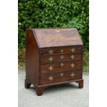 A George III style mahogany bureau, the fall front opening to reveal a fitted interior, the front