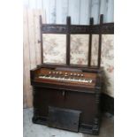 A Victorian Harmonium, having five octaves and various stops, pedal action, each side supported on
