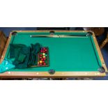 A Debut pool table, with cues and balls