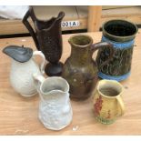A collection of ceramic jugs, to include:- a creamware example with a pewter lid; a stoneware