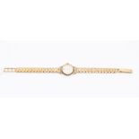 A 9ct gold ladies Accurist watch, round silvered dial with applied gold tone baton markers, diameter