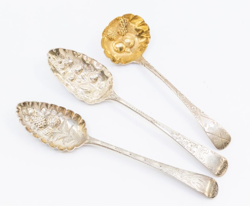 Two George III silver berry spoons, London, 1800 & 1804 together with a George IV sauce ladle,