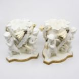 A pair of Moore Bros cherub bowls each with three cherubs and orchid detail  chips to rim