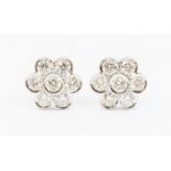 A pair of diamond flower cluster stud earrings, comprising round brilliant cut diamonds, total