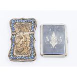 A Thai white metal filigree and blue enamel shaped cigarette case, the front and back decorated with