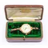 An early 20th century Ladies 9ct rose gold watch, round enamel dial with number markers and