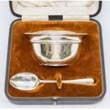 A George V plain silver bowl and matching spoon (Christening Set), hallmarked by Walker & Hall,