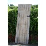 A pine shed door, with wrought iron handle and lock