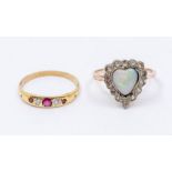 An early 20th century opal 9ct gold ring, comprising a heart shaped opal within a border of small