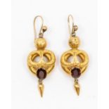 A pair of Victorian garnet and gold drop earrings, serpent like textured overlay with oval garnets