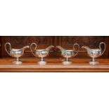 A set of four George III ogee shaped sauce boats, beaded border and foot rims, reeded loop handles