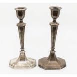 A pair of Edwardian silver octagonal shaped candlesticks, fluted sections, hallmarked by William