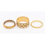 Two 22ct gold bands, size K and L, weight approx. 6.6gms along with a wide 9ct gold band heavily