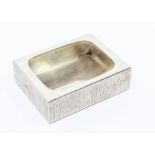 A Modernist silver rectangular bowl, rusticated sides, hallmarked by Gerald Benney, London, 1972,