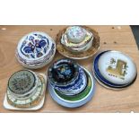 A large collection of ceramic plates and saucers, consisting of a variety of designs and makers, all