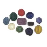 A collection of coloured glass seals, eleven approx