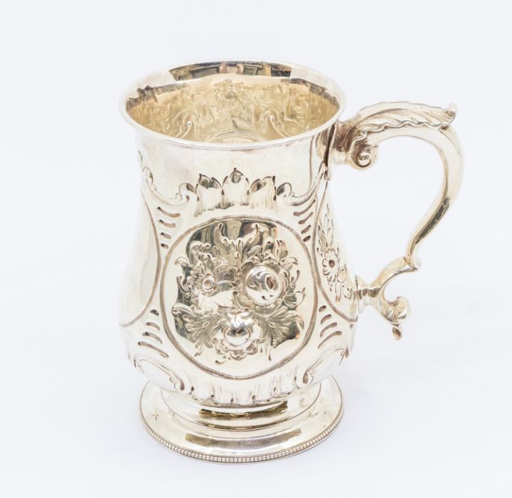 A Victorian silver baluster tankard, profuse chased floral decoration to body, C-scroll handle