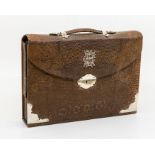 A Victorian silver mounted snake skin travelling writing case, the satchel body opening to reveal