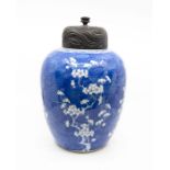 Chinese blue & white ginger jar decorated with prunus with wooden cover.