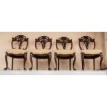 A set of six Victorian rosewood dining chairs, the oval backs with scroll carved crest rails,