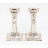 A pair of Edwardian Neo-Classical candlesticks, Corinthian capitals above column with ribbon tied