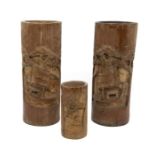 A pair of carved bamboo brush pots, appox 28.5cm high; together with another smaller, approx 14cm