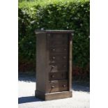 A mid Victorian oak Wellington chest, comprising seven short graduated drawers, with a single