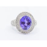 A tanzanite and diamond 18ct white gold dress ring, comprising an oval cut AAA tanzanite claw set to