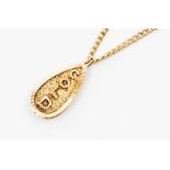 A 9ct gold and diamond tear shaped pendant, the front of textured form with a border of small