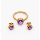 An amethyst and 9ct gold ring, set with an oval stone within a rope border, size Q,  along with a