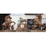 A spelter clock with two Culson matching garnitures, central mantle clock with horse figure above