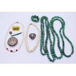 A collection of green stone necklace together with a silver vesta case and another white metal