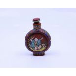 A Chinese Yixing clay snuff bottle depicting scenes of lohan