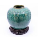 A Chinese Qing dynasty ginger jar on wooden stand