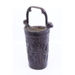 An antique bronze Holy water vessel with swing handle