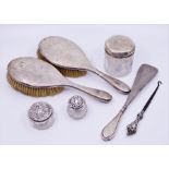 A collection of silver and silver plated items to include silver backed brushes
