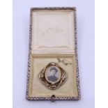 A gold brooch. boxed