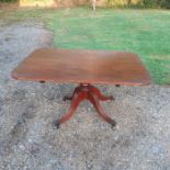 A 19th cent mahogany "snap" top table raised on outswept supports