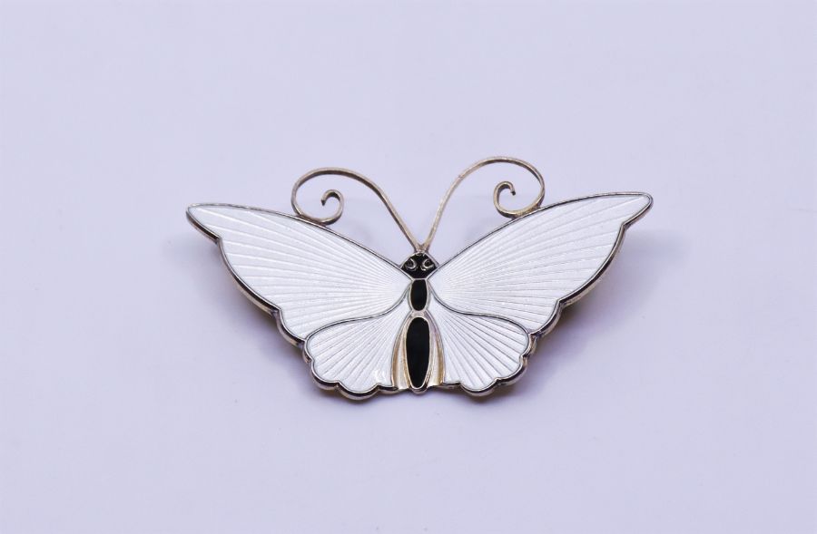 A David Andersen Norwegian sterling silver butterfly brooch, with ivory enamel and black body,