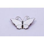 A David Andersen Norwegian sterling silver butterfly brooch, with ivory enamel and black body,