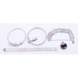 A collection of silver jewellery to include a silver locket. a silver vesta case and bracelets and