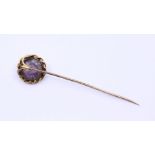 A Georgian gold tie pin with carved purple stone possibly amethyst  intaglio