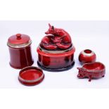 A collection of Royal Doulton Flambe glaze pottery designed by Charles Noke to include a silver