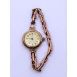 A lady's 9ct rose gold cased watch with Arabic number and 9ct expanding bracelet
